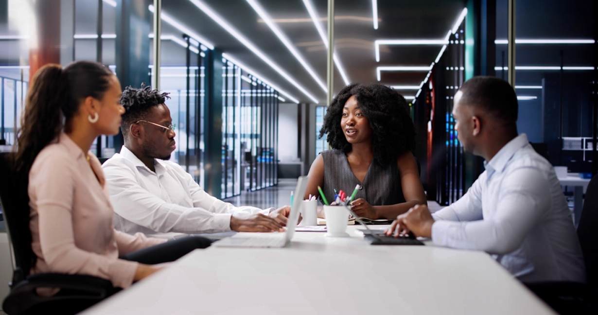 Team meeting in an office discussing logistics strategy.