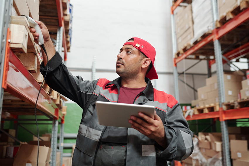 Man working in a warehouse with a tablet